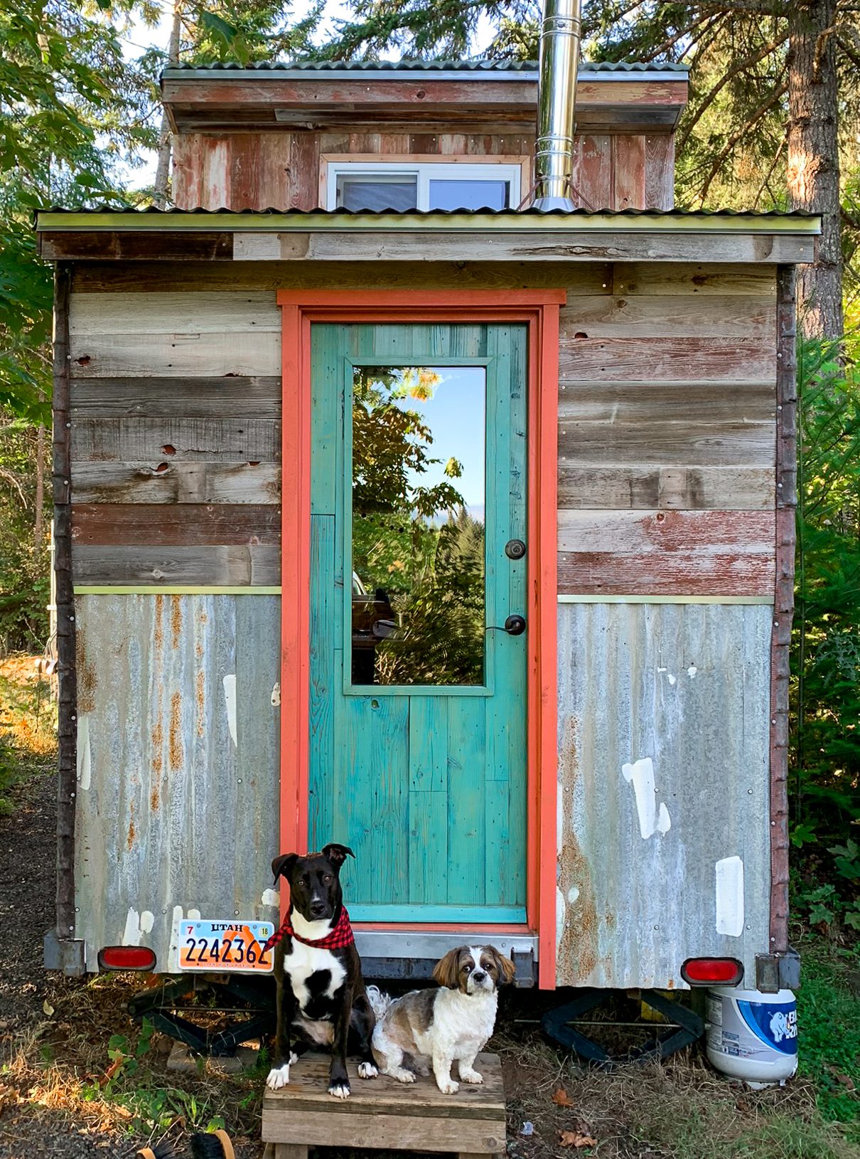 Zella and Caesar posing in front of the tiny house