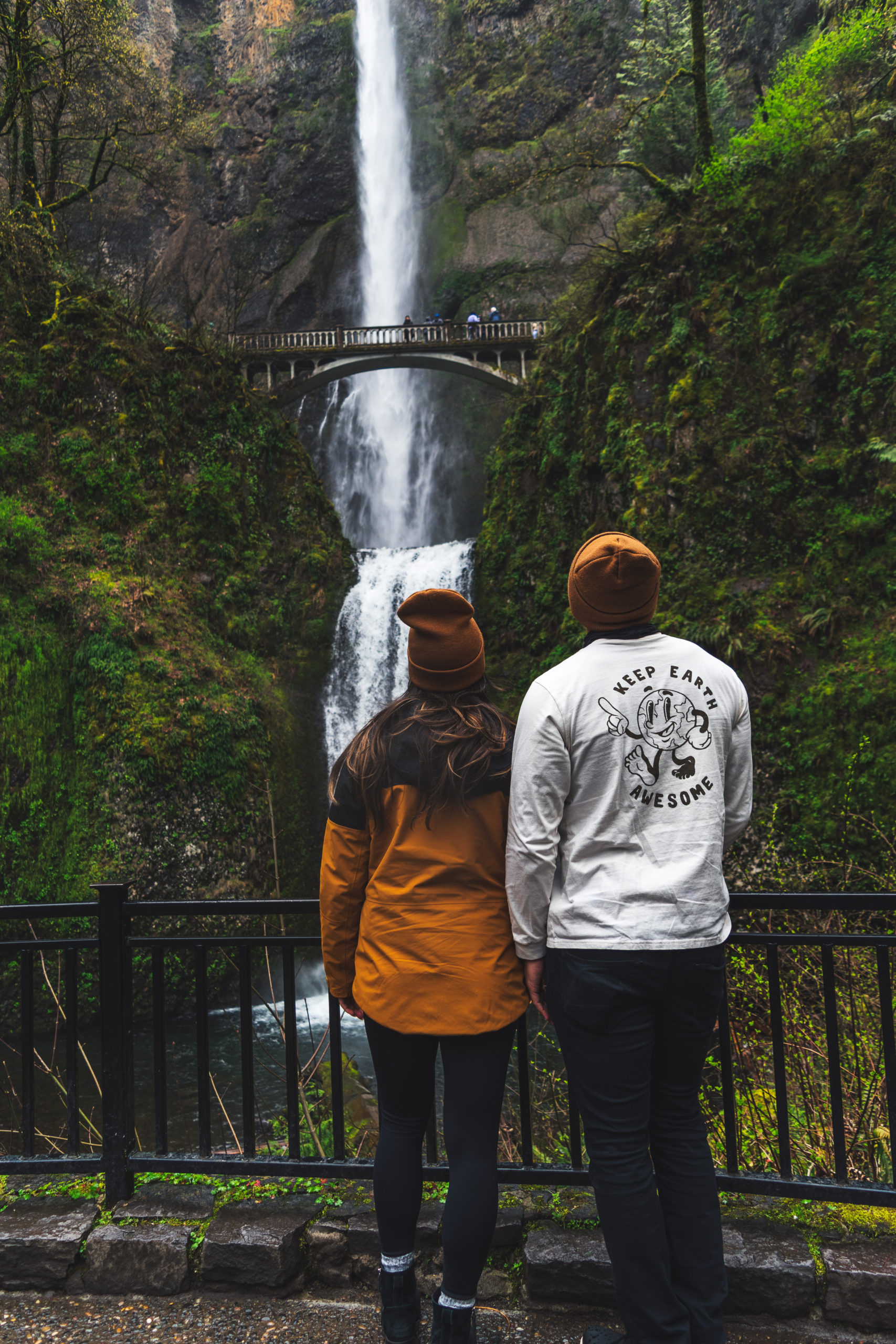 Mia and Jay standing in front of Multnomah Falls