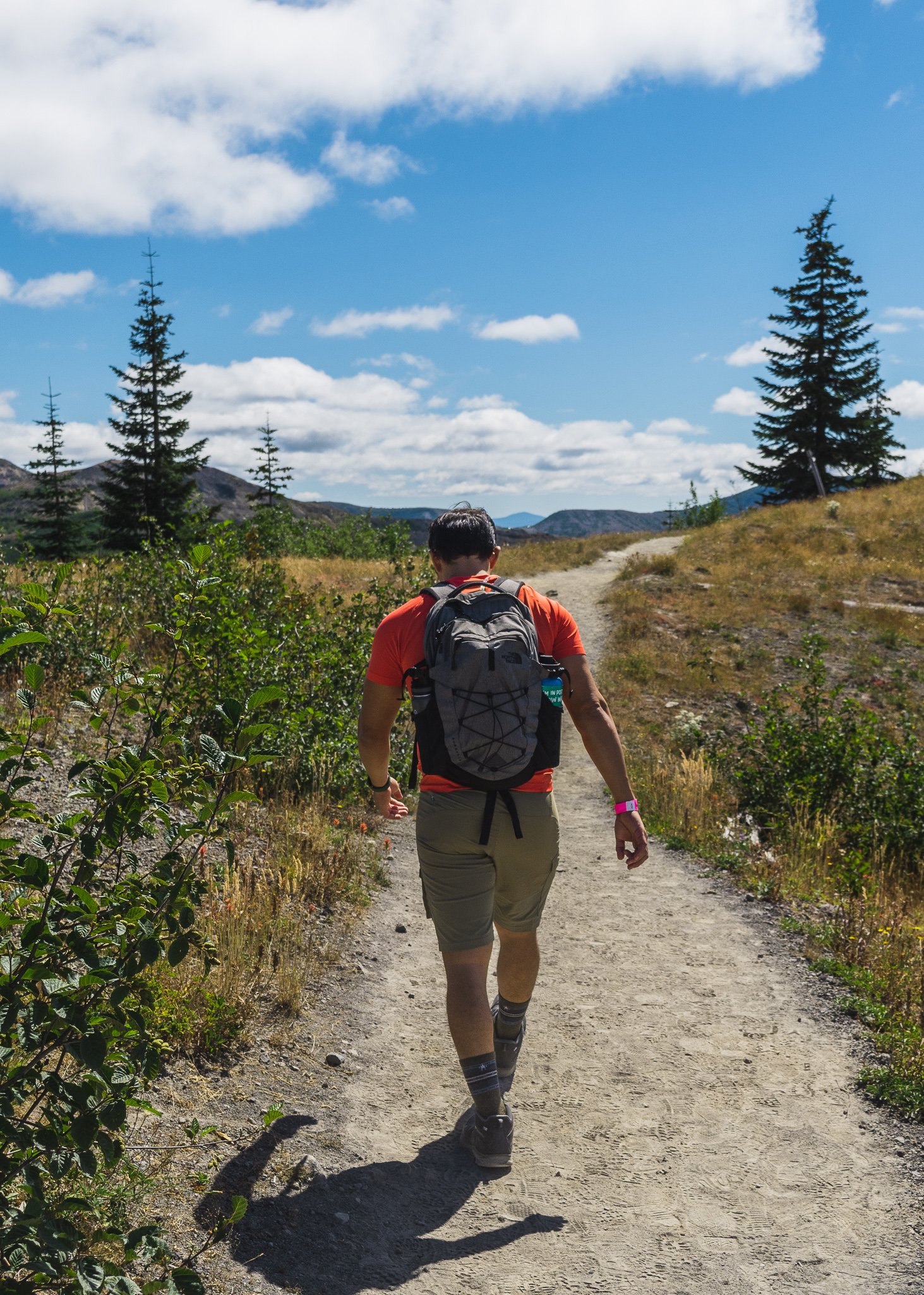 Jay on a hiking trail with all the gear he needs in his backpack