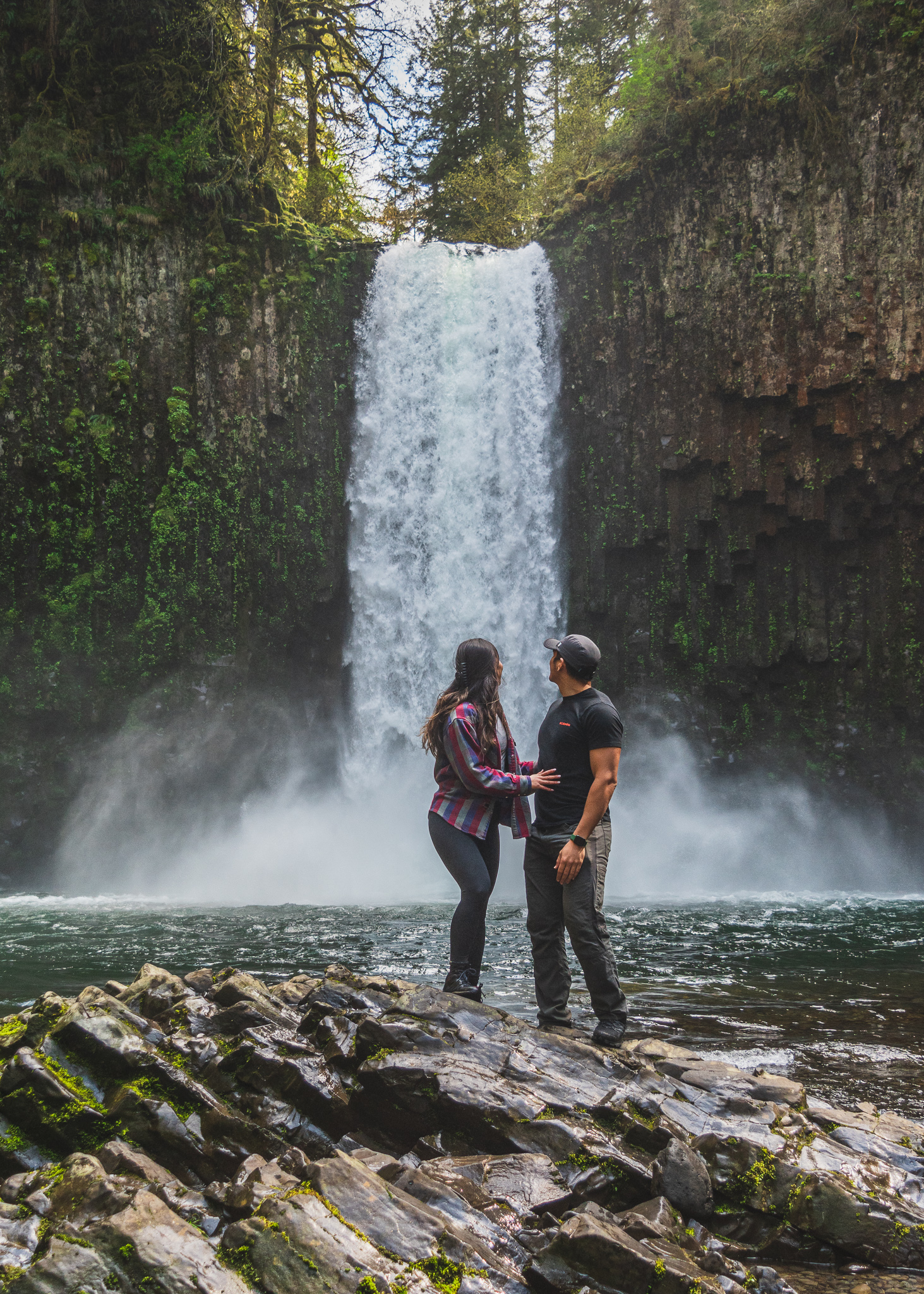 Mia and Jay standing on a rock admiring Abiqua Falls