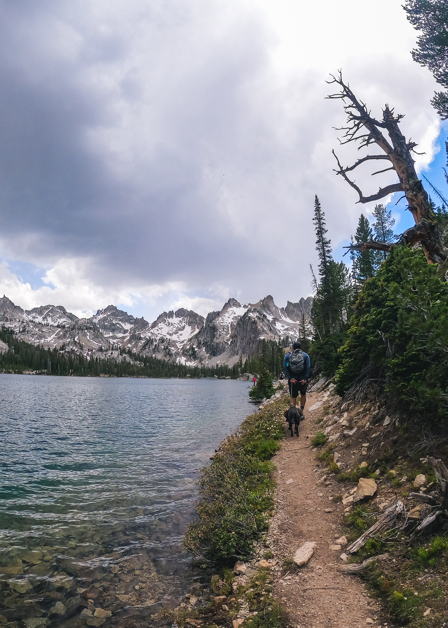 Jay and his dog hiking next to Alice Lake in the Sawtooth Mountains in Idaho.