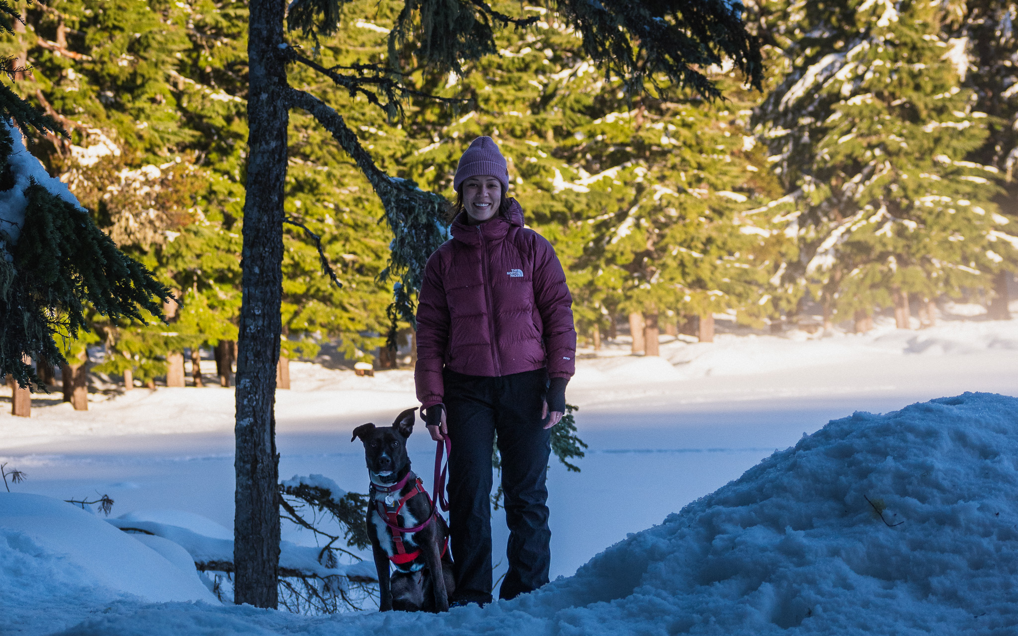 Mia and her dog Zella at Lower Twin Lake on a snowshoeing hike in winter