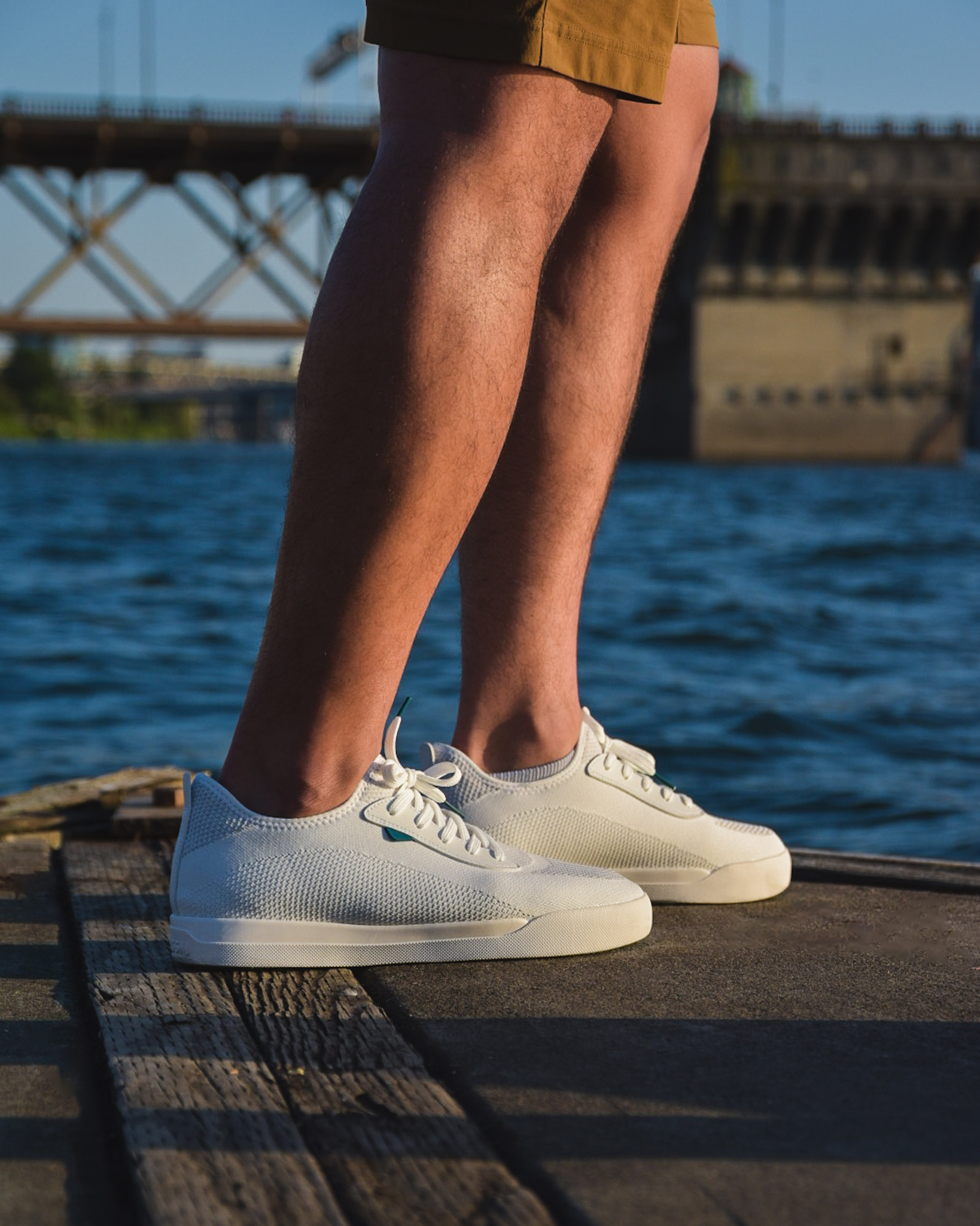 Product photo of Jay wearing the white Vessi Weekend sneakers on the Portland waterfront